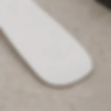 Close-up of a pristine blank white skateboard deck showcasing its smooth surface.