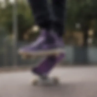 Skateboarder performing a trick while wearing black and purple Nikes.