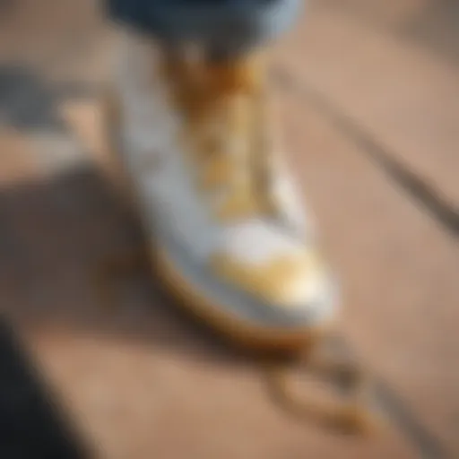 Close-up of gold tip shoelaces on a skateboard deck