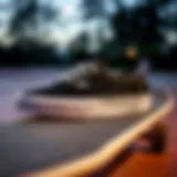 Black and grey Vans sneakers displayed on a skateboard