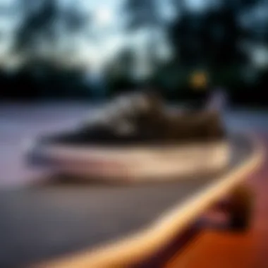 Black and grey Vans sneakers displayed on a skateboard