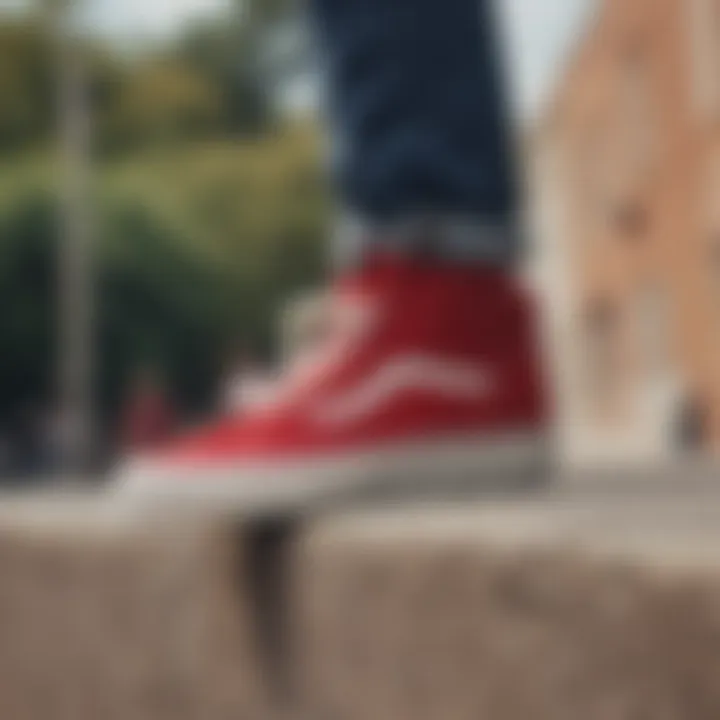 A person styling red suede Vans with casual attire