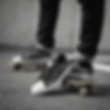 Artistic shot of black and white Adidas shoes on a skateboard