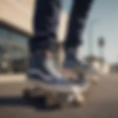 A skateboarder wearing navy hightop Vans while performing a trick.