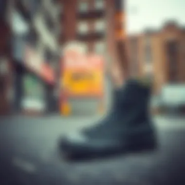 Close-up of all black hightop shoes against an urban backdrop