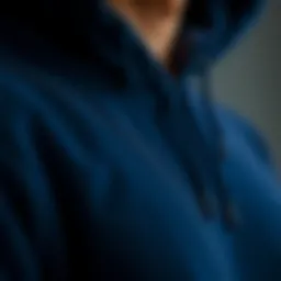 A close-up view of a dark blue hoodie showcasing its texture and fabric details