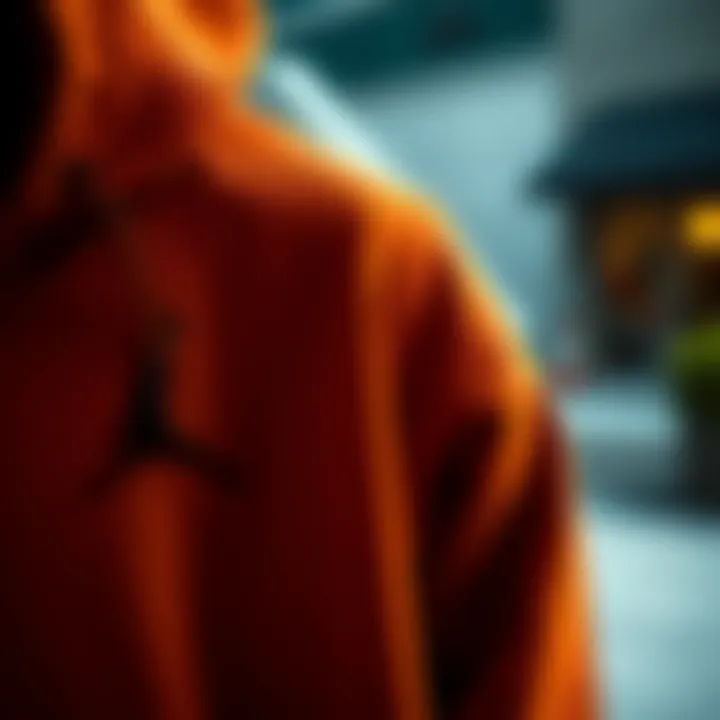 Close-up of a dark orange hoodie highlighting its fabric and design.