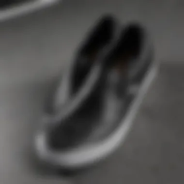 Close-up of the texture and stitching of a black leather slip-on Vans shoe