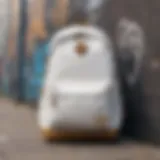 Stylish white and gold backpack displayed against a graffiti wall